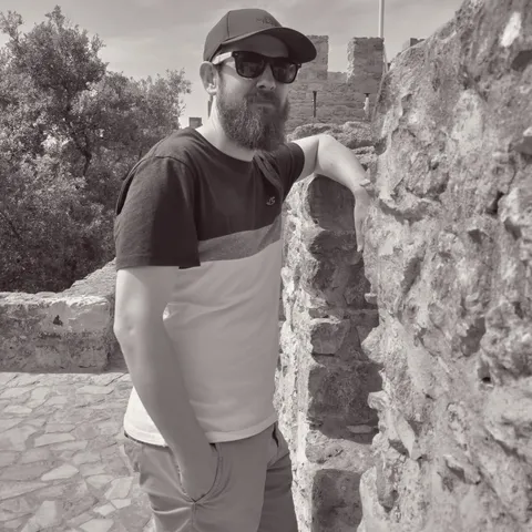 James at ancient stone ruins with sunglasses