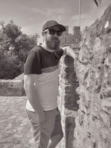James at ancient stone ruins with sunglasses