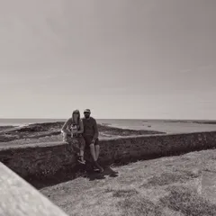 Laura and James with Rosie by coast
