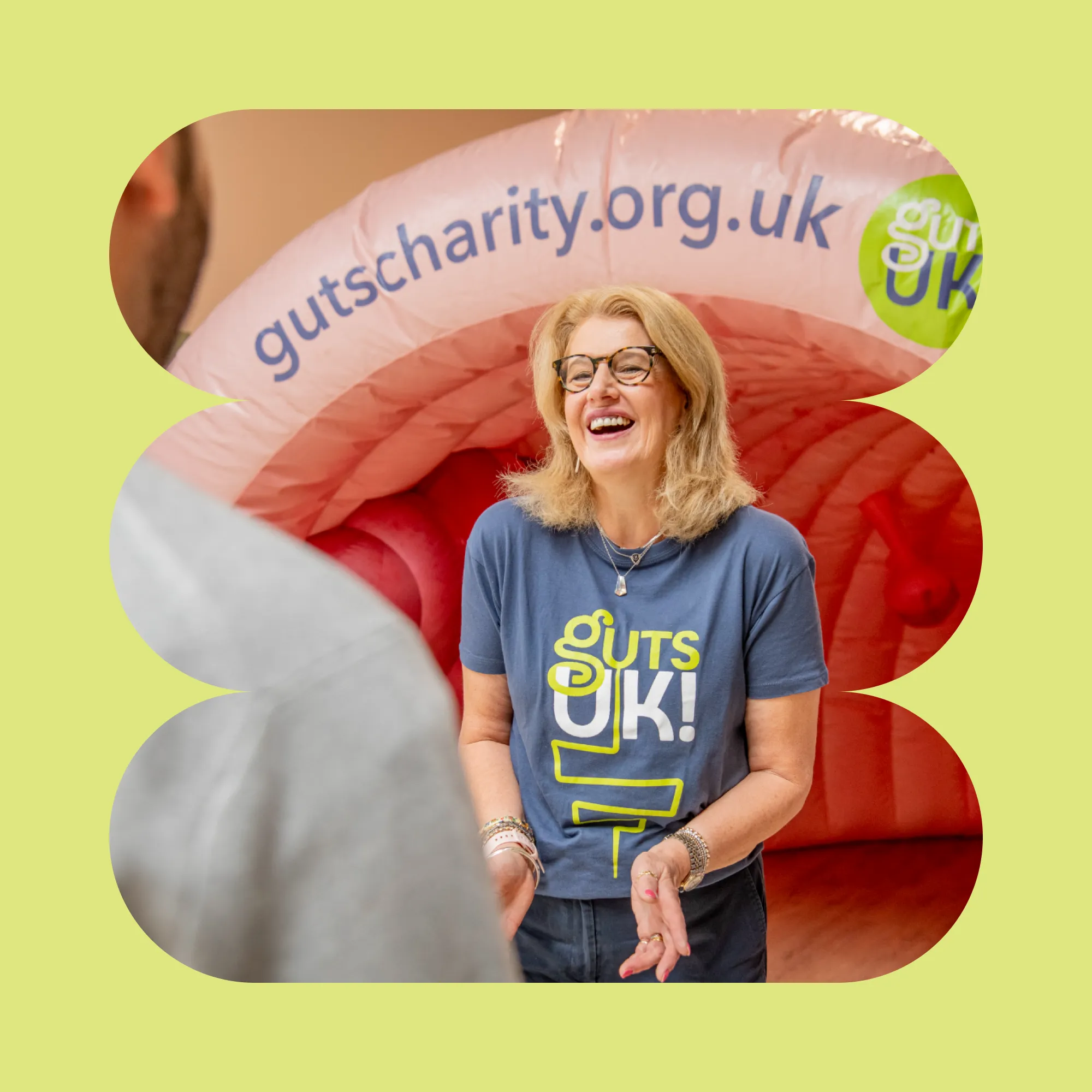 A woman in a Guts UK branded t-shirt laughing