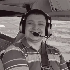 Phill in aircraft cockpit with headset