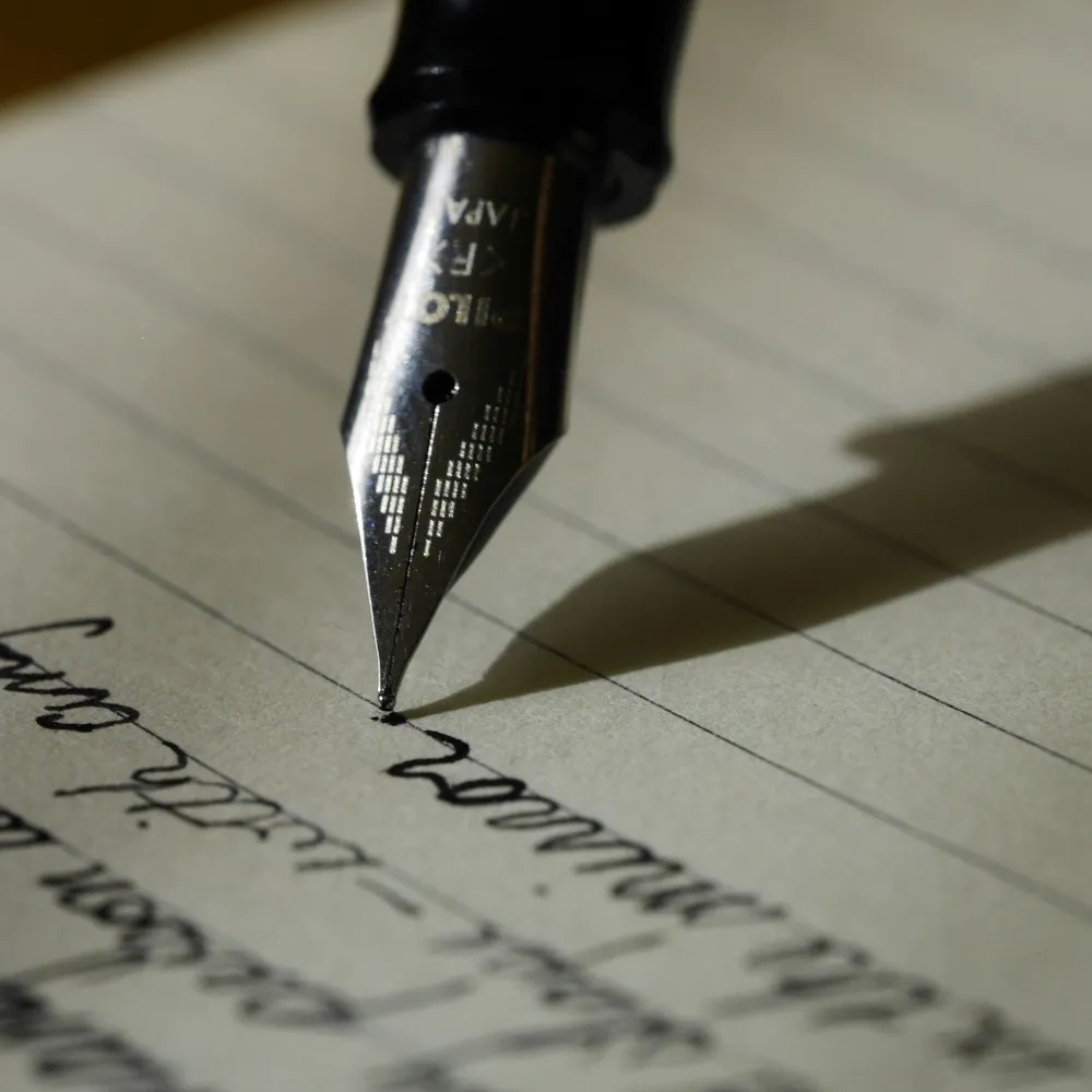 A fountain pen writing on some paper