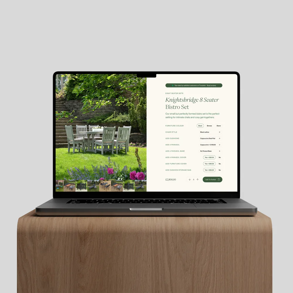 Laptop showing online store page for Knightsbridge 8 Seater Bistro Set in a garden.